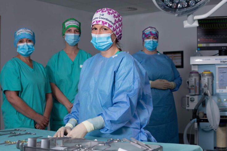 Hospital staff in theatre room wearing reusable headwear.