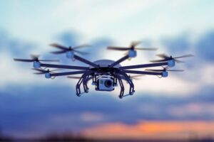 Drone flying across a cloudy sky.