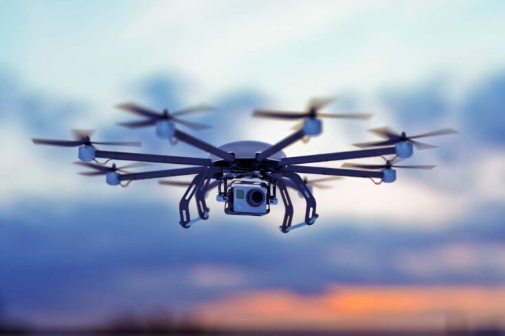 Drone flying across a cloudy sky.