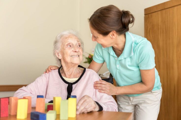 Caregiver with elderly dementia patient.