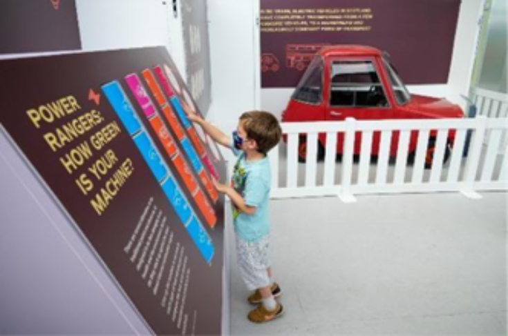 A child interacting with a display in a museum.