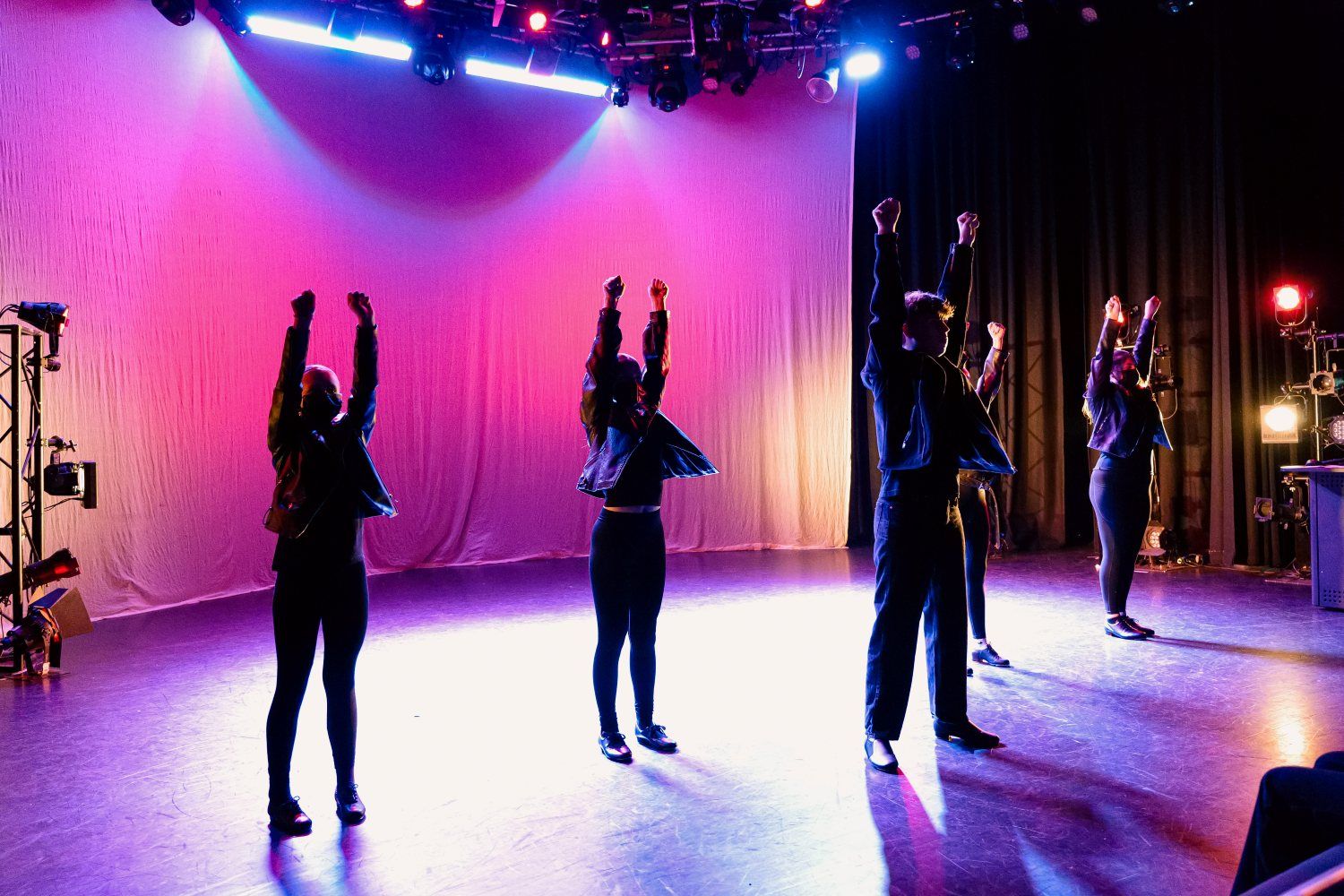 A photo of performers from the ArtZCentre youth group on stage.