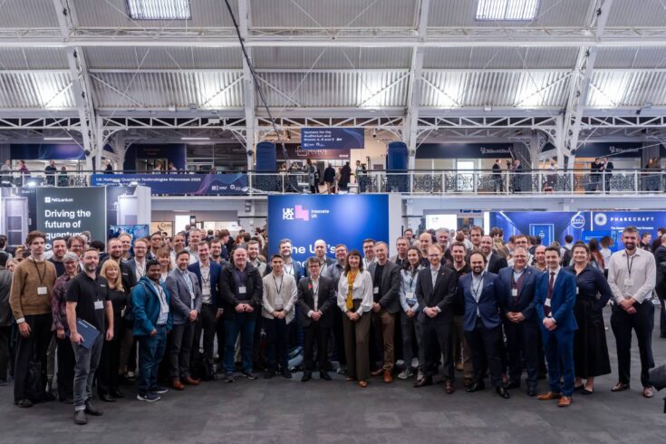 Large group of people standing together at the UK National Quantum Technologies Showcase.