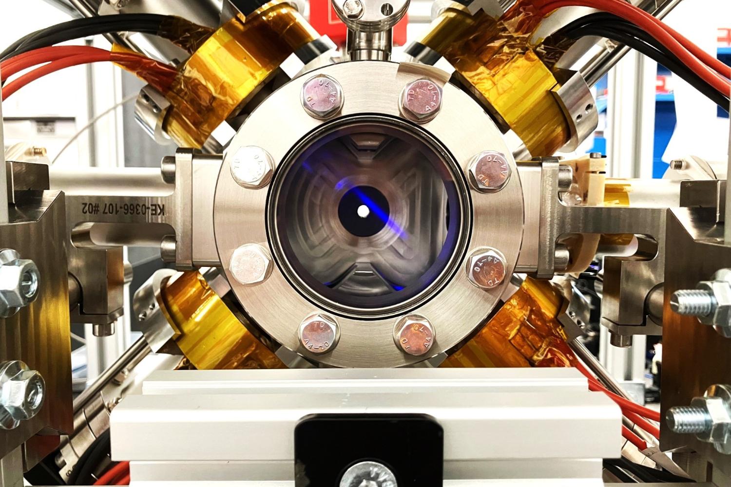 Strontium atoms within the High Flux Atom Interferometry Source vacuum chamber, observed as the blue fluorescent line.