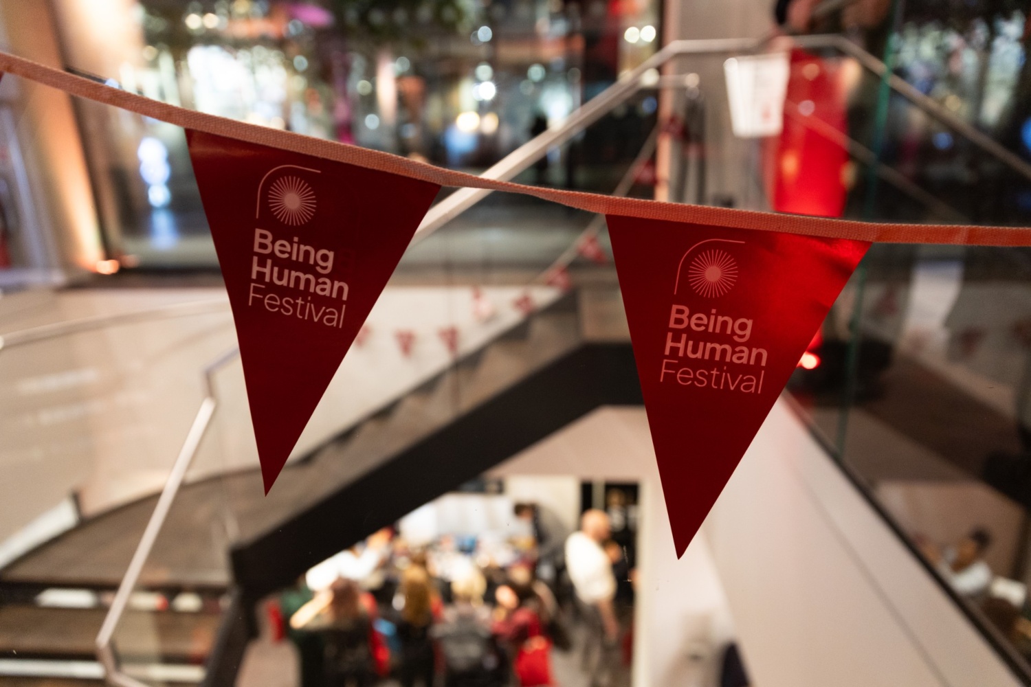A close up of the Being Human Festival branded red bunting on display at the festival