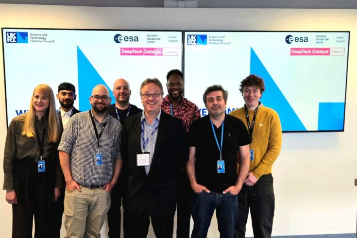 A group of colleagues smiling for a photo.