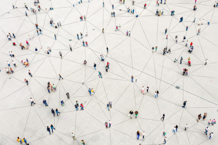 An aerial view of a group of people spread out across lines on the ground.